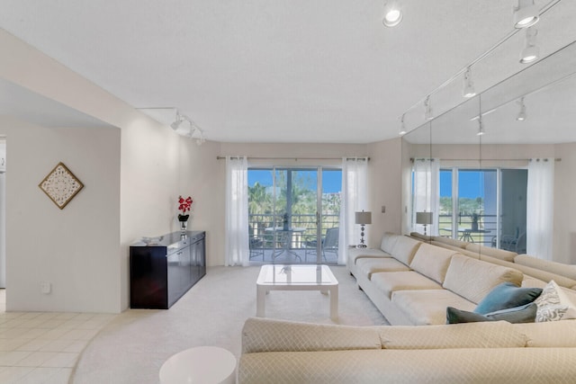 tiled living room featuring track lighting