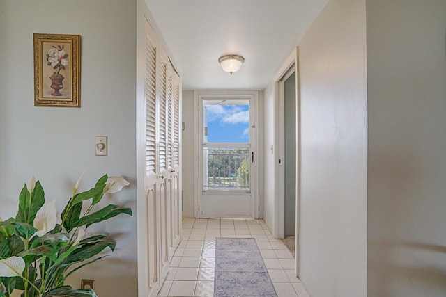 doorway with light tile patterned flooring