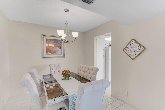 dining room featuring an inviting chandelier and light tile patterned flooring