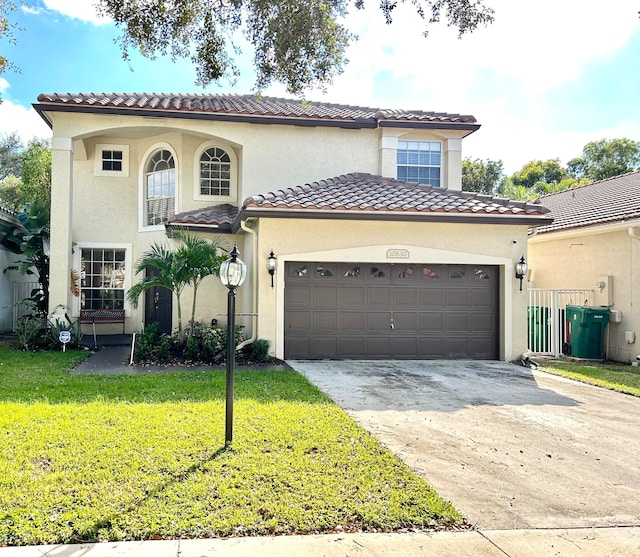 mediterranean / spanish house with a garage and a front lawn