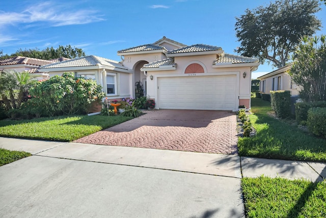 mediterranean / spanish-style home featuring a garage and a front lawn