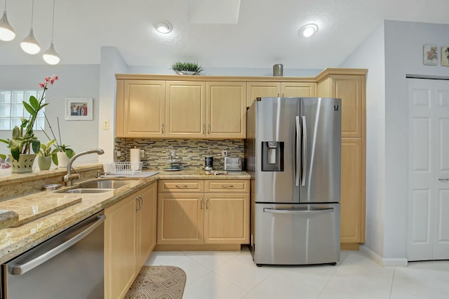 kitchen featuring light brown cabinetry, tasteful backsplash, stainless steel appliances, sink, and pendant lighting