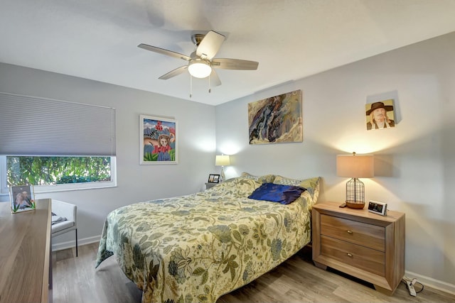 bedroom with light hardwood / wood-style floors and ceiling fan