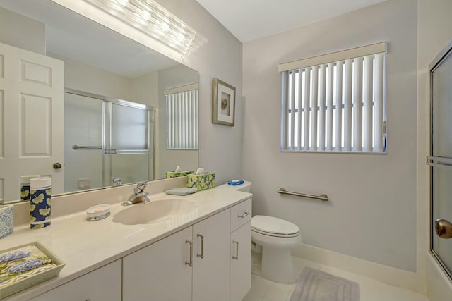 bathroom featuring tile patterned flooring, vanity, and toilet