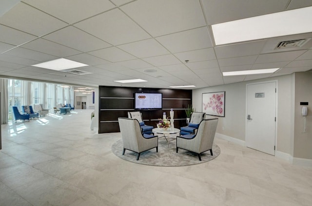 living room featuring a paneled ceiling