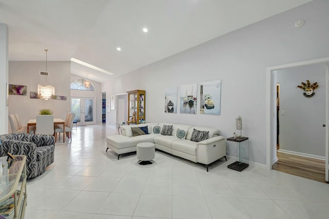 tiled living room featuring french doors, high vaulted ceiling, and an inviting chandelier