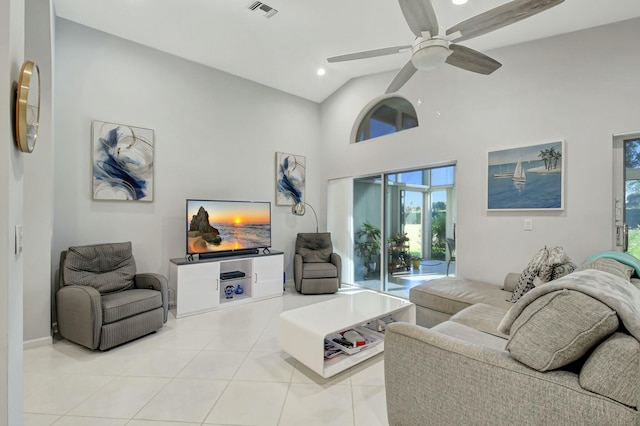 tiled living room featuring ceiling fan and high vaulted ceiling