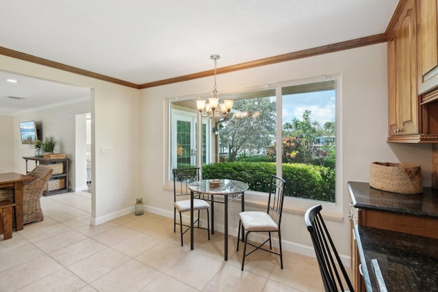 dining room featuring light tile patterned floors, ornamental molding, and a chandelier