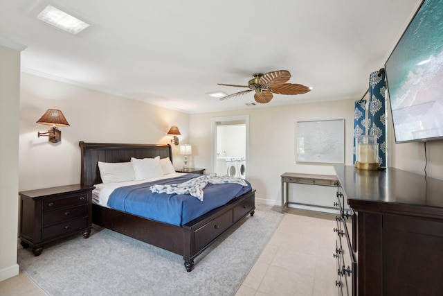 bedroom featuring ceiling fan and separate washer and dryer