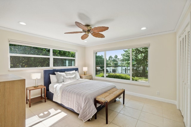 bedroom featuring a water view, ceiling fan, crown molding, and light tile patterned flooring