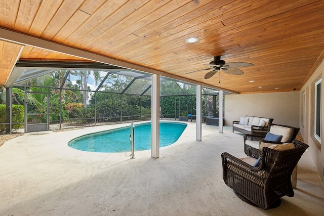 view of pool with a lanai, an outdoor living space, ceiling fan, and a patio area