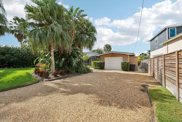 view of yard featuring an outbuilding and a garage