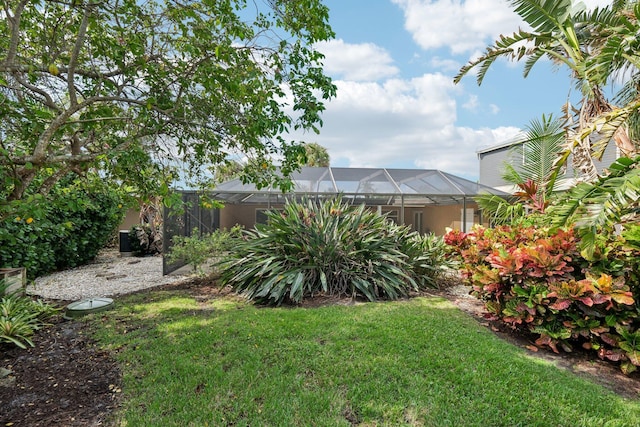 view of yard with glass enclosure