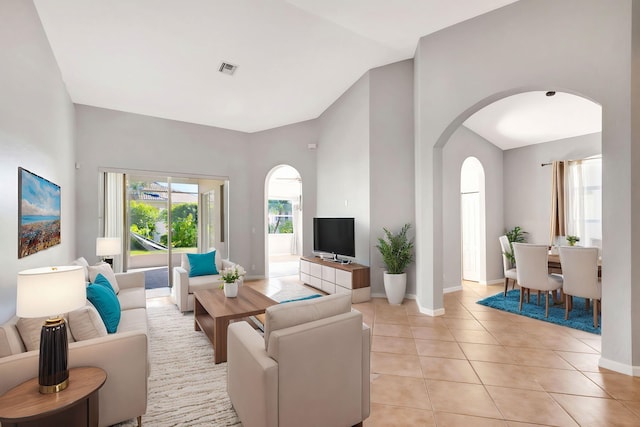 tiled living room featuring vaulted ceiling