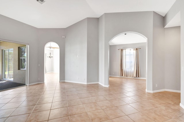 tiled spare room featuring ceiling fan