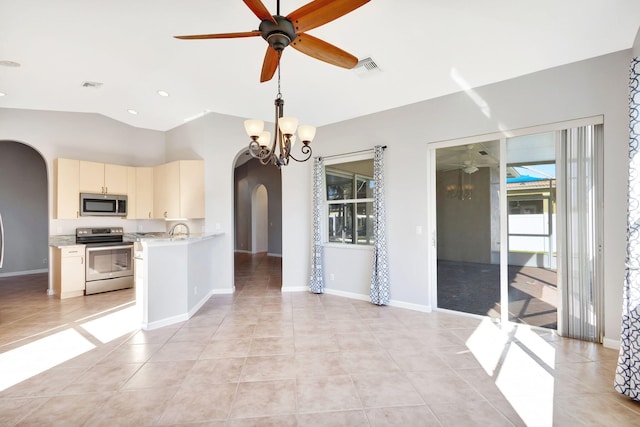 kitchen featuring ceiling fan with notable chandelier, light tile patterned floors, cream cabinetry, and appliances with stainless steel finishes