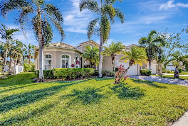 mediterranean / spanish home with a garage and a front yard