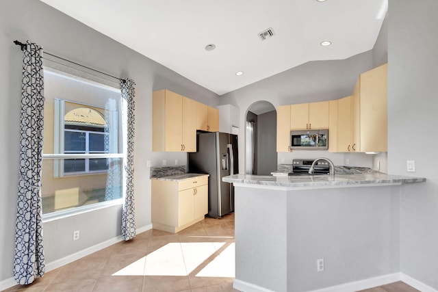 kitchen featuring stainless steel appliances, sink, light tile patterned floors, and kitchen peninsula