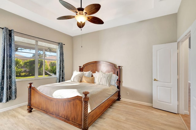 bedroom with ceiling fan and light hardwood / wood-style floors