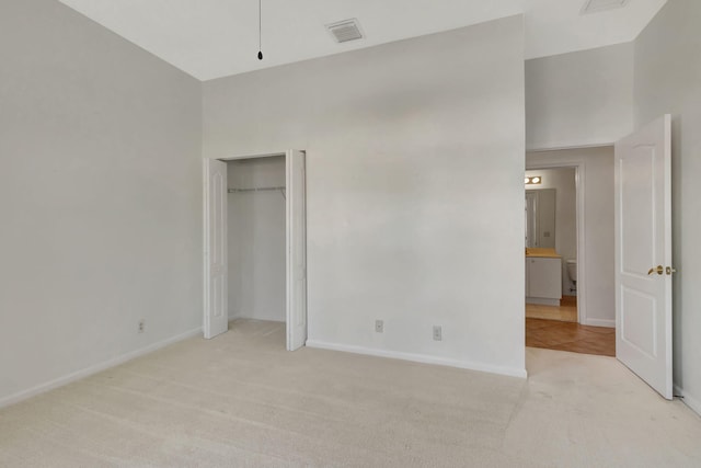 unfurnished bedroom featuring light carpet