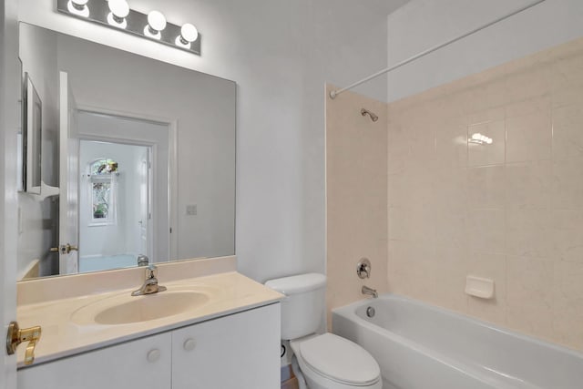 full bathroom featuring toilet, vanity, and tiled shower / bath combo