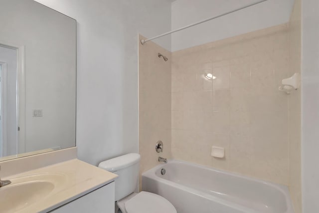 full bathroom featuring toilet, tiled shower / bath, and vanity