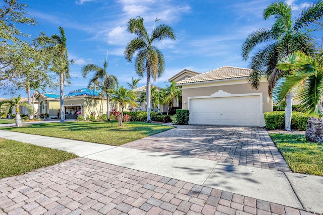 view of front of house with a front yard and a garage