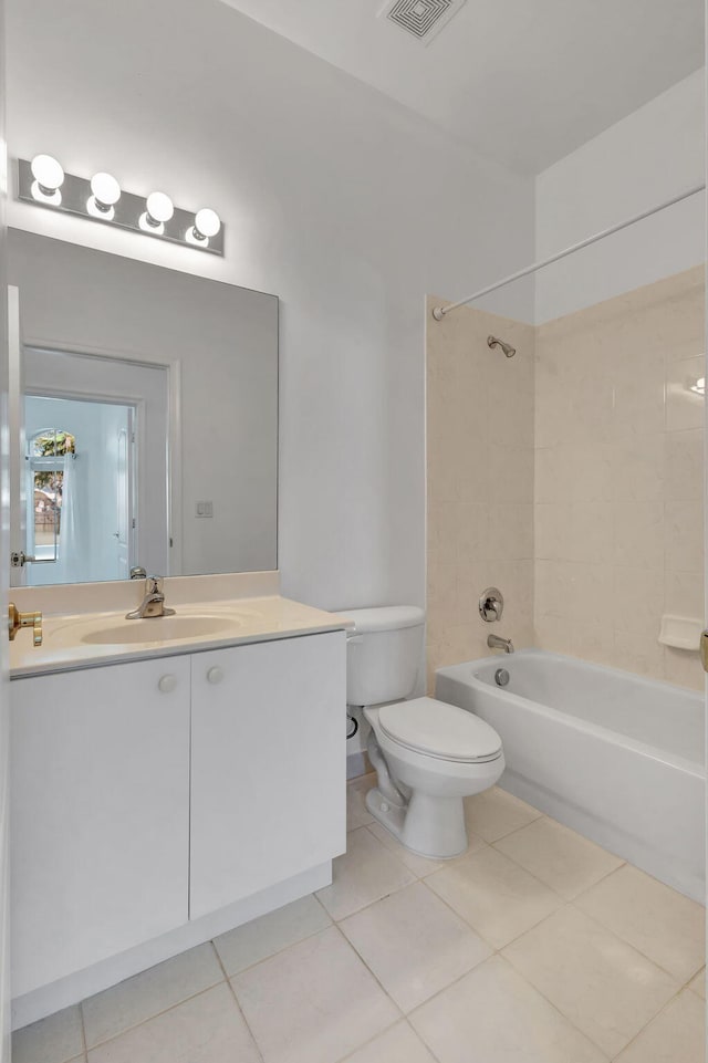 full bathroom with toilet, tile patterned flooring, tiled shower / bath, and vanity