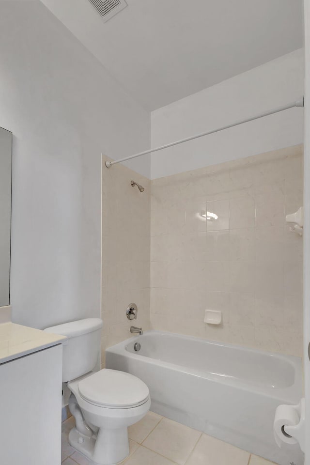 full bathroom with tile patterned flooring, toilet, vanity, and tiled shower / bath