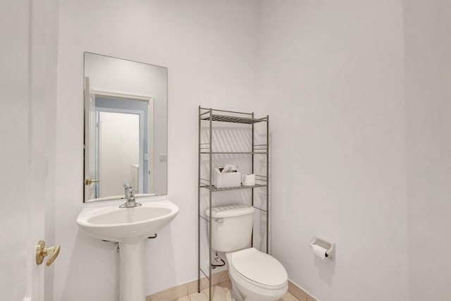 bathroom with toilet and tile patterned flooring