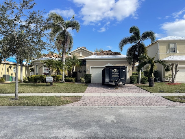 view of front of home with a front yard and a garage