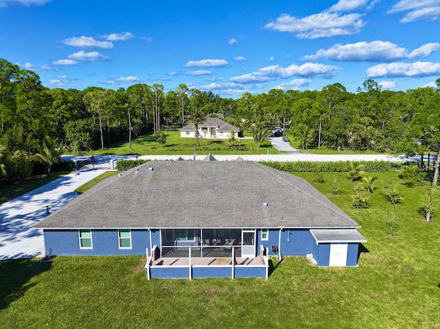 rear view of house featuring a yard