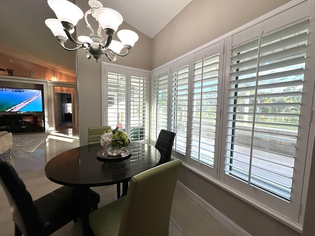 dining room featuring a chandelier and vaulted ceiling