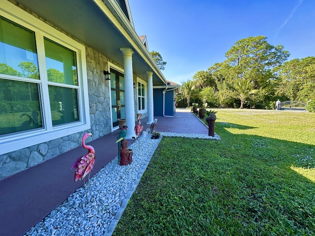 view of yard featuring covered porch