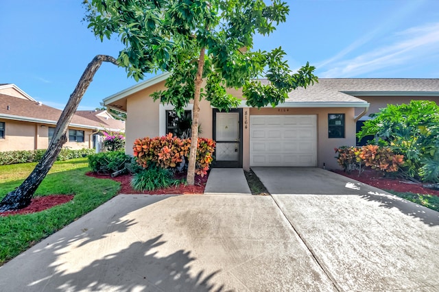 view of front of property with a front lawn and a garage