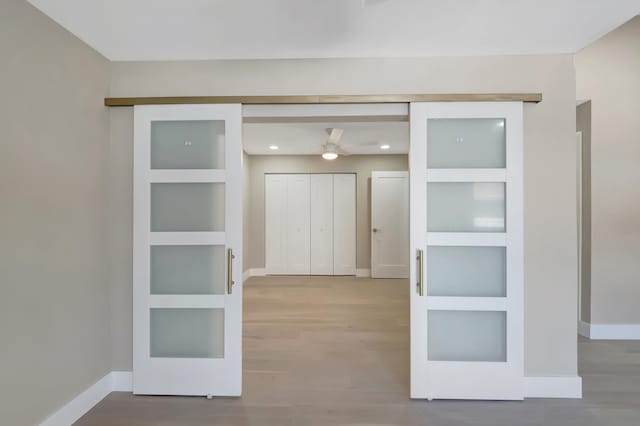 interior space with built in shelves and wood-type flooring