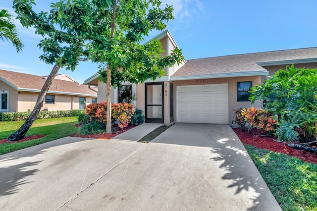 single story home featuring a garage and a front yard