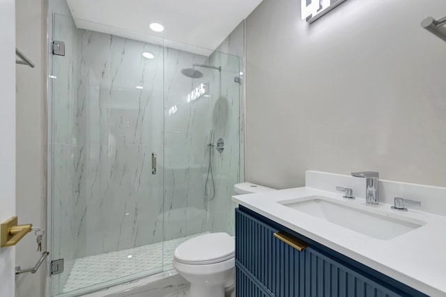 bathroom with an enclosed shower, vanity, and toilet