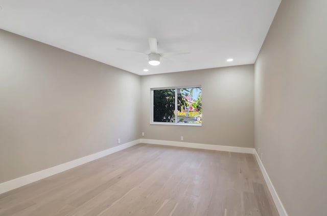 unfurnished room with ceiling fan and light wood-type flooring