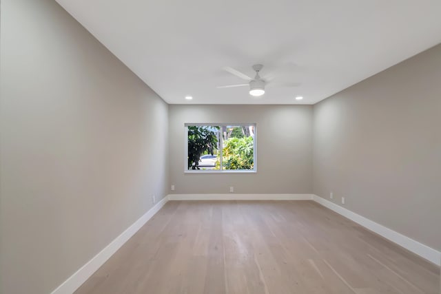 spare room with light wood-type flooring and ceiling fan