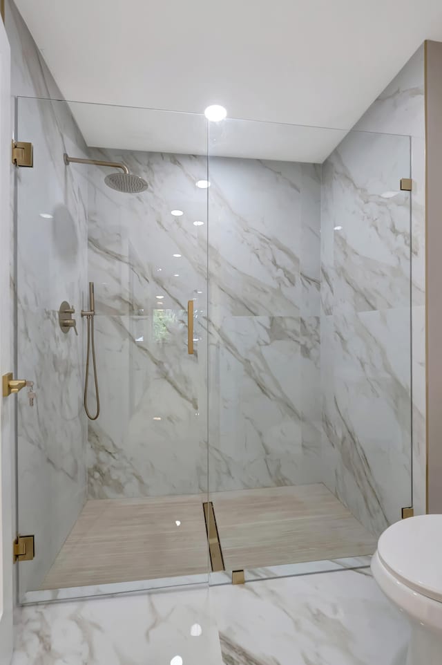 bathroom with toilet and walk in shower