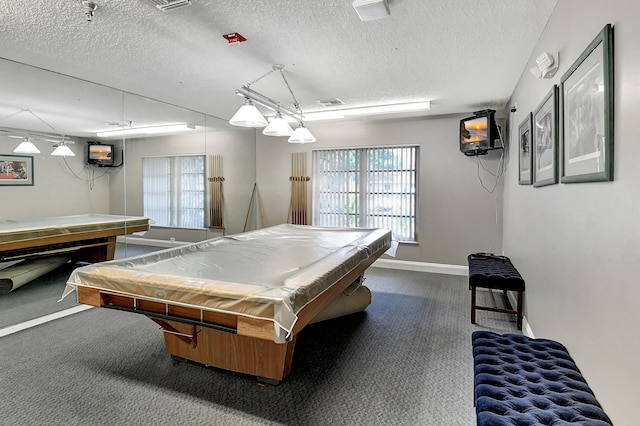 playroom featuring pool table, a textured ceiling, and dark colored carpet