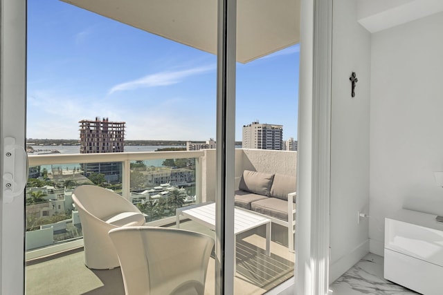 balcony with a water view and a city view