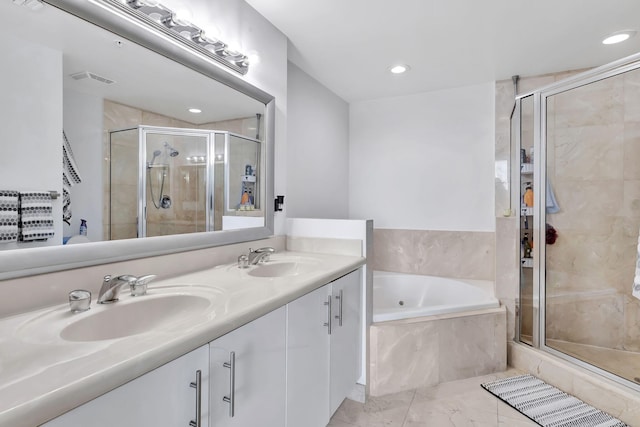 full bathroom featuring double vanity, marble finish floor, a stall shower, and a sink