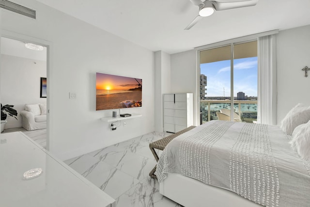 bedroom featuring visible vents, ceiling fan, access to outside, floor to ceiling windows, and marble finish floor