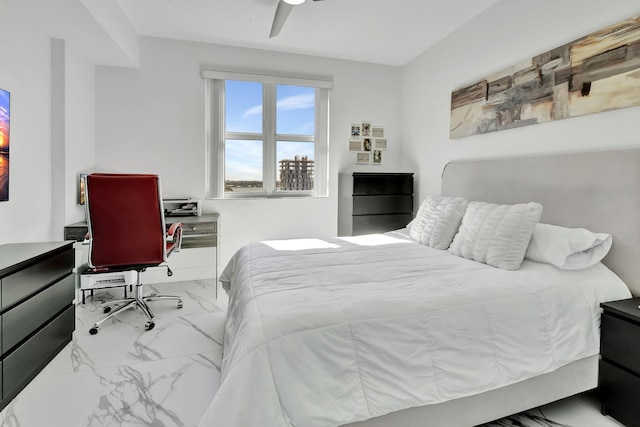 bedroom featuring a ceiling fan and marble finish floor