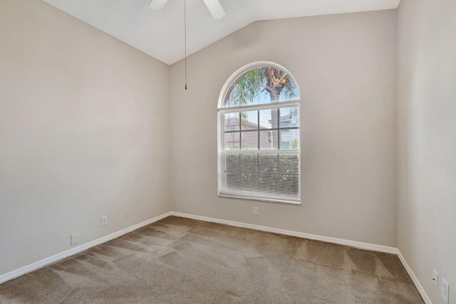 carpeted empty room with vaulted ceiling and ceiling fan