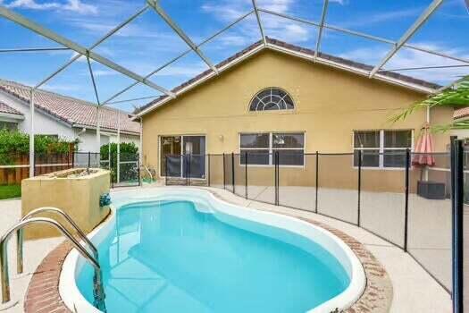 view of pool featuring glass enclosure