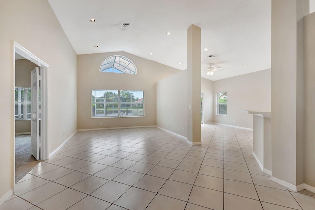 unfurnished living room featuring light tile patterned floors, plenty of natural light, lofted ceiling, and ceiling fan