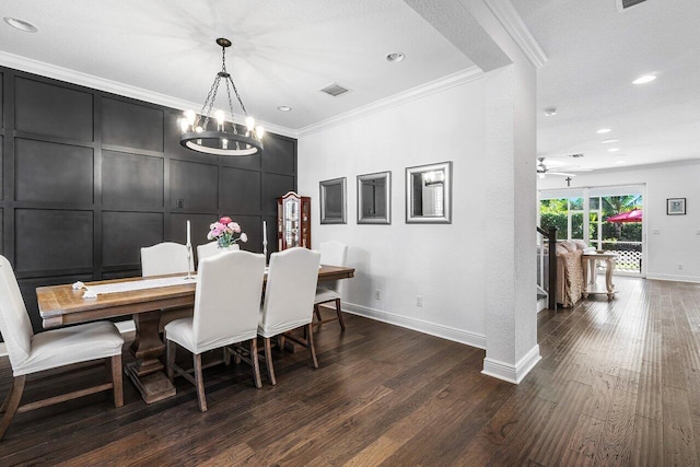 dining room featuring a textured ceiling, dark hardwood / wood-style flooring, crown molding, and an inviting chandelier